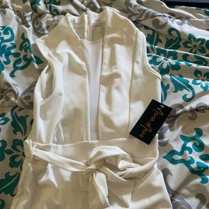 NanaMacs jumpsuit ; ties around the waist. Sleeve less. New with tags.